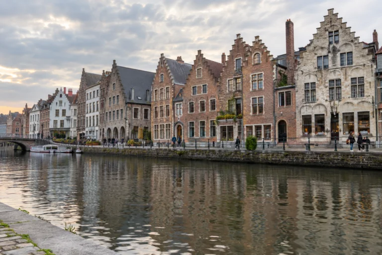 AI-generated illustration of Flemish gabled waterfront buildings and a riverside quay inspired by Ghent.